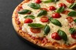 © Belie - Delicious Pizza with Fresh Tomatoes, Mozzarella, and Basil on a Dark Background, Ready to Eat