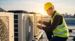 © graphiczone872 - Rooftop hvac technician working on air conditioning units at sunset