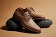 © Jam - Two low cut khaki leather shoes are showcased on polished stones, highlighting their sophisticated design against a warm background