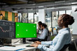 © DC Studio - Trader in prop firm office using using trading app on green screen mockup PC to analyze market data and execute trades. Woman monitoring stock exchange using chroma key isolated screen computer