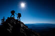 © Secrets inside - Two hikers silhouetted against a bright sun help each other ascend a rocky mountain peak with expansive blue mountain ranges in the background