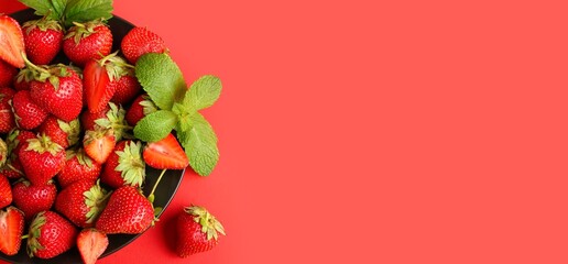 Wall Mural - plate of sweet strawberries on red background with space for text, top view