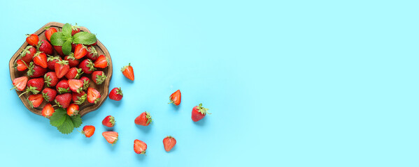 Wall Mural - wooden board and sweet strawberries on light blue background with space for text, top view