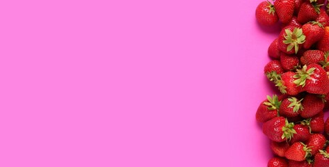 Wall Mural - heap of fresh ripe strawberries on bright pink background with space for text, top view