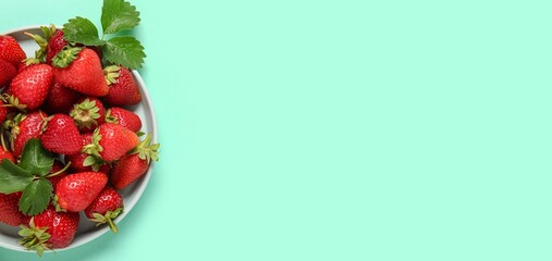 Wall Mural - plate of fresh ripe strawberries on turquoise background with space for text, top view