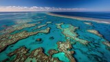 Aerial View of Australia’s Great Barrier Reef with Vibrant Coral Formations in Turquoise Water and Sunlit Wave Patterns, Stunning Natural Wonder from Above
