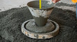 © Item.io - A worker measures the slump of concrete after it has been poured from a cone-shaped container onto a flat surface.