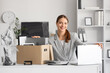 © Pixel-Shot - Young happy businesswoman with laptop and cardboard box of belongings in office on moving day