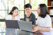 © Nutchapong Wuttisak - In preparation for tomorrow, 3 Asian students work on a project with a laptop, balancing education goals and industry knowledge to strengthen their readiness for the future.