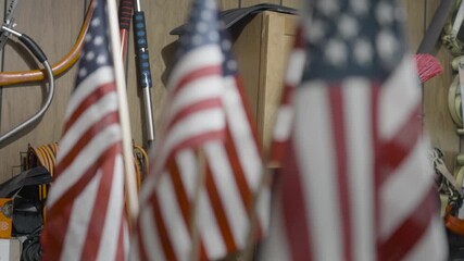 Wall Mural - Lawn flags for memorial day in a vise grip.