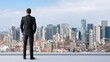 © ittipol - A businessman stands on a rooftop overlooking a vibrant city skyline, reflecting ambition and determination