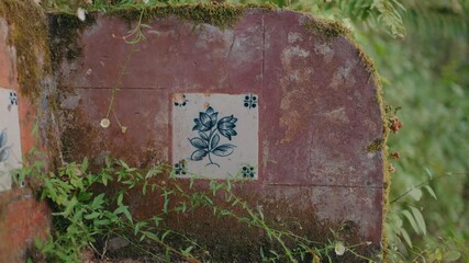 Wall Mural - aged wall with blue azulejo floral tile detail in sintra portugal