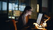 © stockbusters - Financial analyst working computer at night workstation with real time stocks
