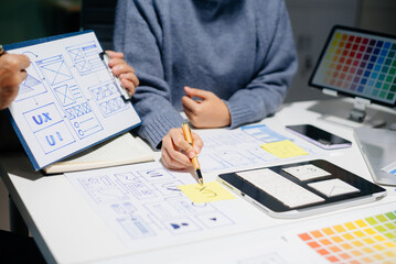 Wall Mural - UX UI design with wireframes, prototypes, and color planning. Creative web design development with real people in a modern tech office.