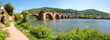 famous Karl-Theodor Bridge, Heidelberg, called Alte Brücke, over Neckar river. footpath at riverside