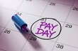 © Risat Designer - A blue marker pen rests on a calendar page highlighting the circled date of pay day in purple ink