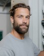 © progressman - Man with a beard and a gray shirt is smiling