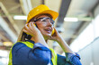 © Dragana Gordic - Female Factory Worker Wearing Safety Gear in an Industrial Setting