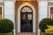 © muteha - A symmetrical view of a dark double door with an arched transom window and white pillars facade decor