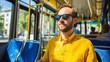 © Oleksandr - Riding public transport on a sunny day. A man gazes out the window on a bus, lost in thought, with sunlit city views passing by.