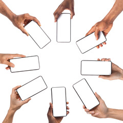 Collection of diverse male and female hands holding cell phones with white empty screen in cirle, showing using devices, sharing media, transfer data files, free copy space. Mock up, studio background