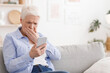 © Prostock-studio - Worried senior lady reading shocking news on smartphone at home, looking at screen and covering mouth with hand in shock, copy space
