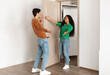 © Prostock-studio - Welcome. Portrait of excited lady greeting guy meeting him at front door, wants to hug, inviting guest to enter her flat, welcoming home, happy couple standing in doorway of new modern apartment