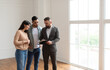 © Prostock-studio - Young married Middle Eastern couple discussing agreement with real estate agent or broker. Professional financial advisor or salesman explaining contract details with millennial clients at meeting