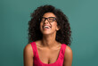 © Prostock-studio - Happy african-american woman laughing over blue background