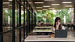 © snowing12 - Asian adult woman remote work laptop outdoor cafe campus quiet setting professional study business project