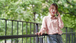 © snowing12 - Asian woman freelancer talk phone remote work outdoor digital nomad connect business communication modern lifestyle productivity nature environment