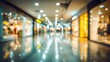 © Mystic - Blurry view of a shopping mall hallway with glossy floors reflecting the lights from the shops. Warm tones and out-of-focus details