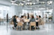 © Echo - A blurred photo depicts a meeting of numerous people around a table in a bright room with large windows, giving an impression of collaboration