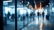 © Golden - Blurred office scene with people walking down a corridor, glass walls, and a cold, professional ambiance, creating a sense of movement and business