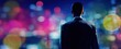 © sya - The businessman contemplating the vibrant city lights from an urban viewpoint.