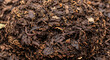 © iam00 - Close-up view of dark brown soil mixture with organic matter.