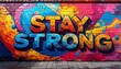 © Digistock - Colorful graffiti art featuring the empowering phrase Stay Strong on brick wall