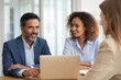 © Vision Glow - Diverse Business Team Meeting with Laptop and Smiling