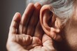 © Prazis Images - Elderly person with wrinkled hand trying to listen and eavesdrop on a conversation