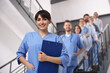 © New Africa - Medical assistant and other healthcare workers in hospital, selective focus