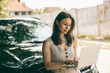 © milanmarkovic78 - Woman Using Laptop Beside Her Car
