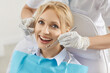 © Studio Romantic - Portrait of a positive woman patient during dental appointment with doctor dentist in dentistry clinic, focusing on stomatology and medical care in a professional setting with satisfaction.