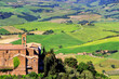 Old church and farm fields in Montalcino town, Val d'Orcia, Tuscany, Italy