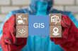 © wladimir1804 - Engineer holding blocks with icons sees the acronym GIS. GIS Geographic Information System Modern Industry 4.0 Software Database Transportation Tracking Concept.