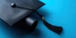© Artem - Close-up of graduation cap and diploma, representing academic achievement on blue.