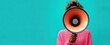 © sunny - person wearing pink sweater holding orange megaphone close to face against blue background
