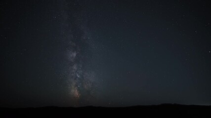Wall Mural - Timelapse of the Milky Way in the sky above the horizon