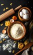 © Fikri Haikal - Overhead shot of baking ingredients: flour, eggs, and rolling pin on dark background