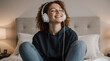 © Nai - Teen girl enjoys music while relaxing on her bed in a cozy bedroom during the evening hours