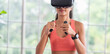 © weedezign - Asian woman wear virtual reality glasses and train boxing with joystick control at home